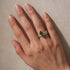 Green marquise side stone ring worn for everyday style