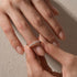 Woman stacking a marquise half eternity wedding band