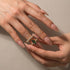 Woman styling a green marquise wedding ring set