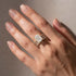Cushion cut ring with emerald cut band on hand