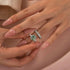 Green moissanite ring with two-tone nesting band