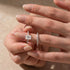 Rose gold radiant moissanite wedding set held in fingers