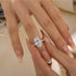 Oval cut hidden halo engagement ring worn on hand