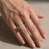 White gold hidden halo wedding set styled on a woman’s hand