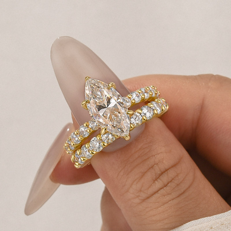 Close-up of marquise moissanite ring with side stones