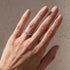 V-shaped sterling silver wedding band worn on hand