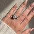 Woman wearing a blue and white cushion cut wedding ring set