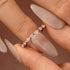 Rose gold marquise stackable wedding band on hand