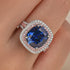 Blue cushion double halo ring close-up