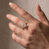 Oval Cut Hidden Halo Wedding Set Close-Up on Hand