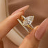 Close-up of a marquise cut ring held between two fingers
