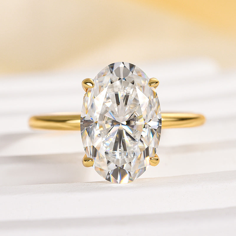Close-up of yellow gold oval cut solitaire engagement ring
