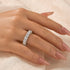 White gold round cut eternity wedding band on finger