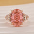 Pink oval ring with half-moon side stones