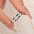 Blue Wedding Ring Enhancer Held Between Fingers