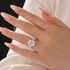 Three stone cushion cut moissanite engagement ring on finger