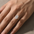 Side view of woman wearing an oval cut engagement ring