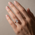 Oval cut solitaire engagement ring styled on a woman’s hand