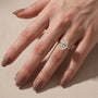 Yellow gold oval engagement ring shown during everyday wear