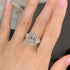 Cushion cut three stone engagement ring on hand