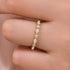 Moissanite Yellow gold marquise half eternity wedding band on finger