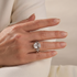 Colorful cushion cut wedding ring set styled on a woman’s hand