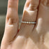 White gold round cut eternity wedding band on finger