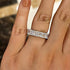 Cushion cut eternity wedding band worn on hand