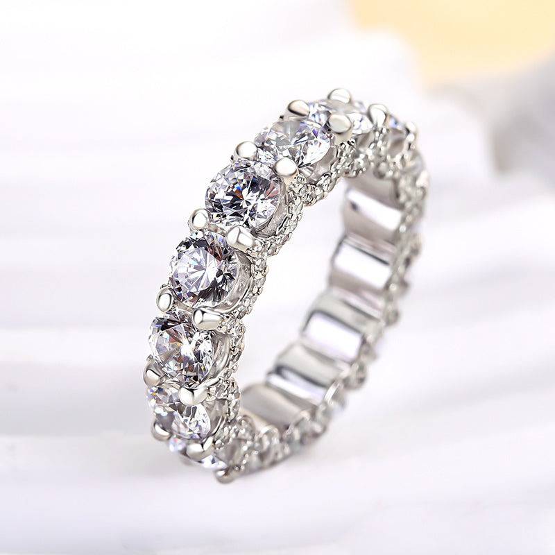 Angled view of white gold round cut eternity band