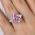 Pink sapphire three stone engagement ring on hand
